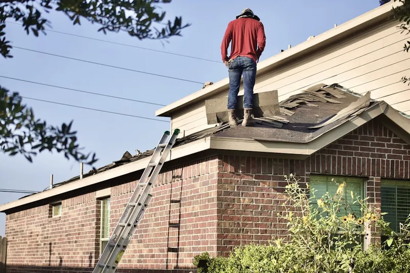 Professional roofer working on a residential roof in North Weedsport